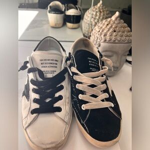 Original finish/wear Golden Goose Super Star low top black/white sneakers.